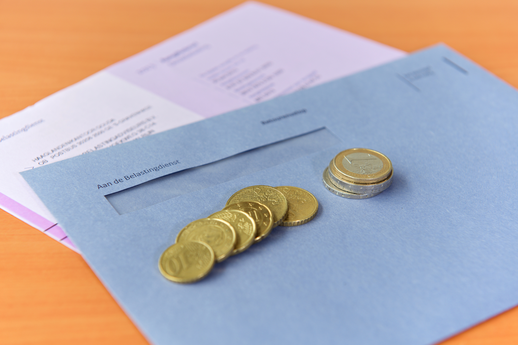 Tax declaration with envelope and Euro coins
