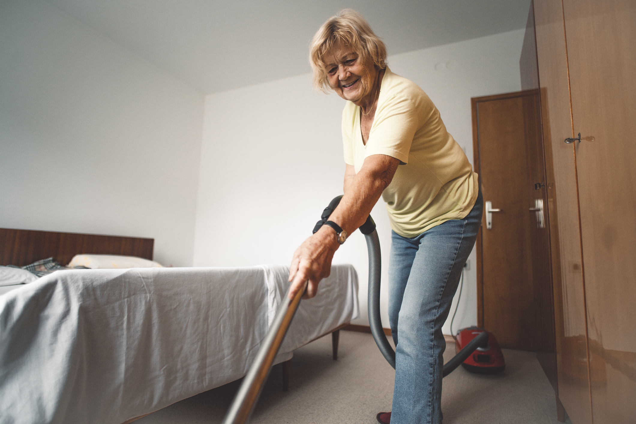 Woman cleaning the bedroom