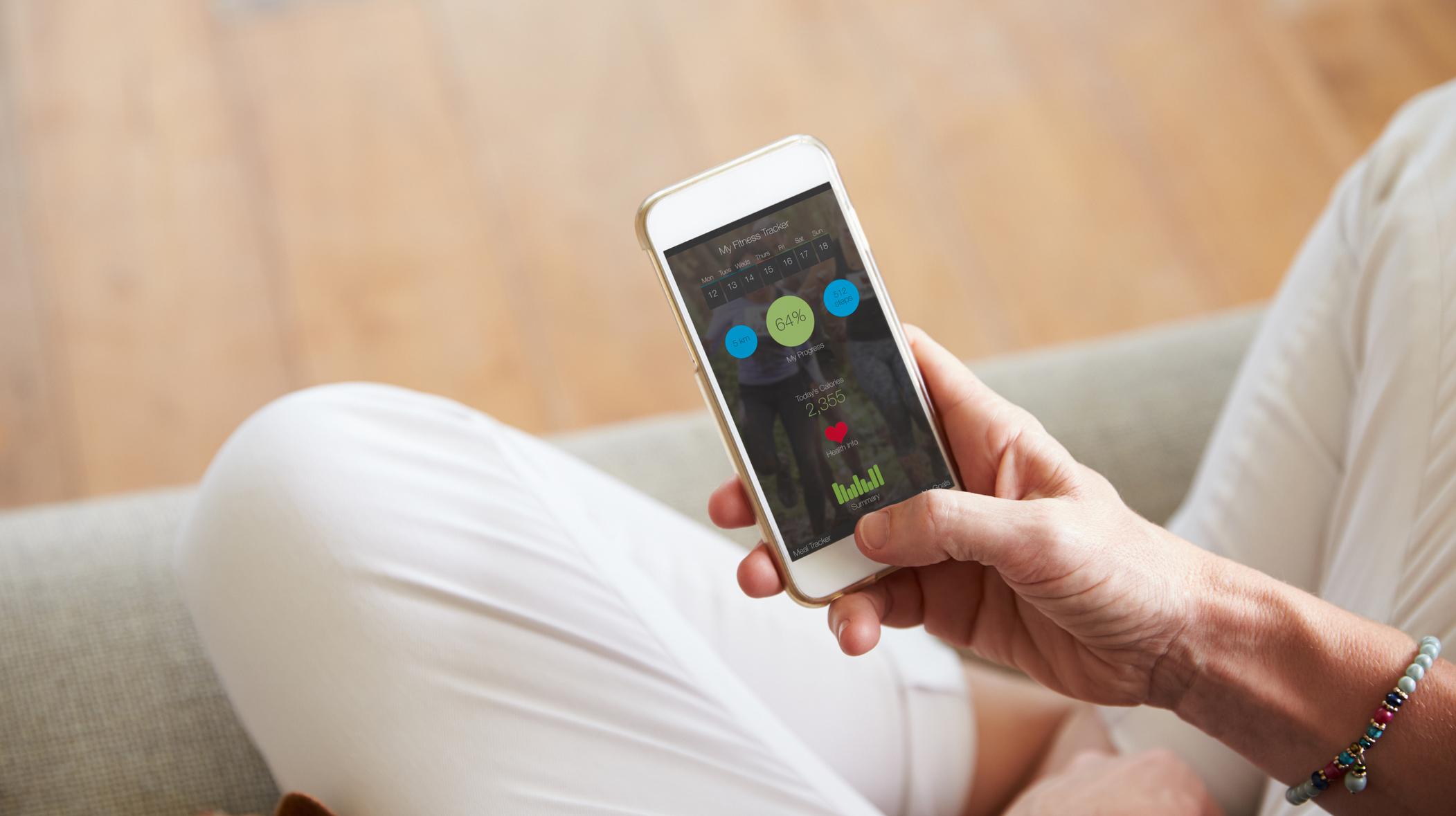 Woman Looking At Health Monitoring App On Smartphone