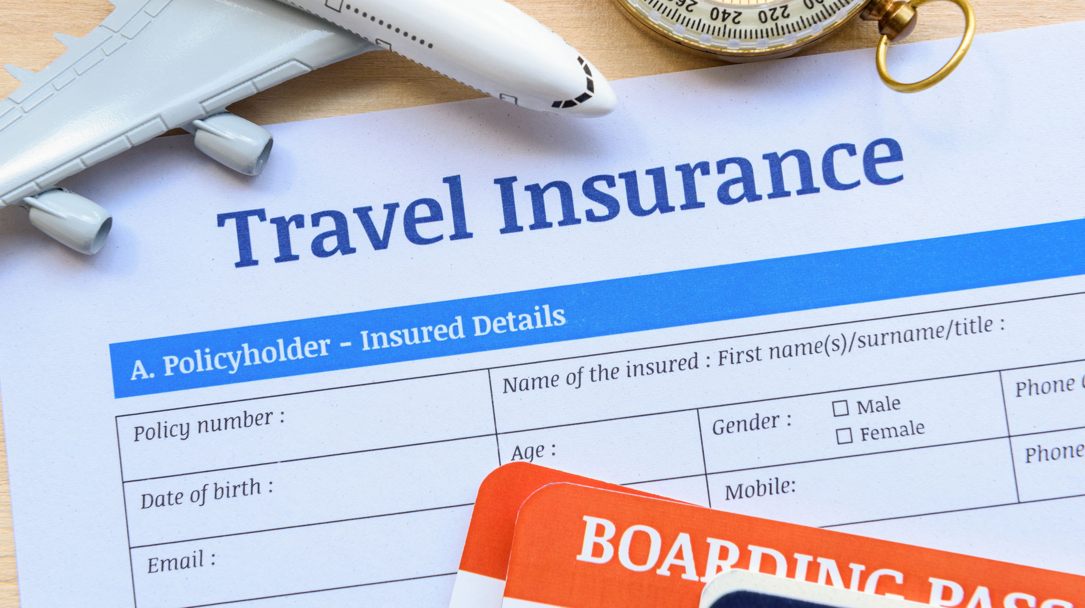 Travel insurance form put on a wood table.