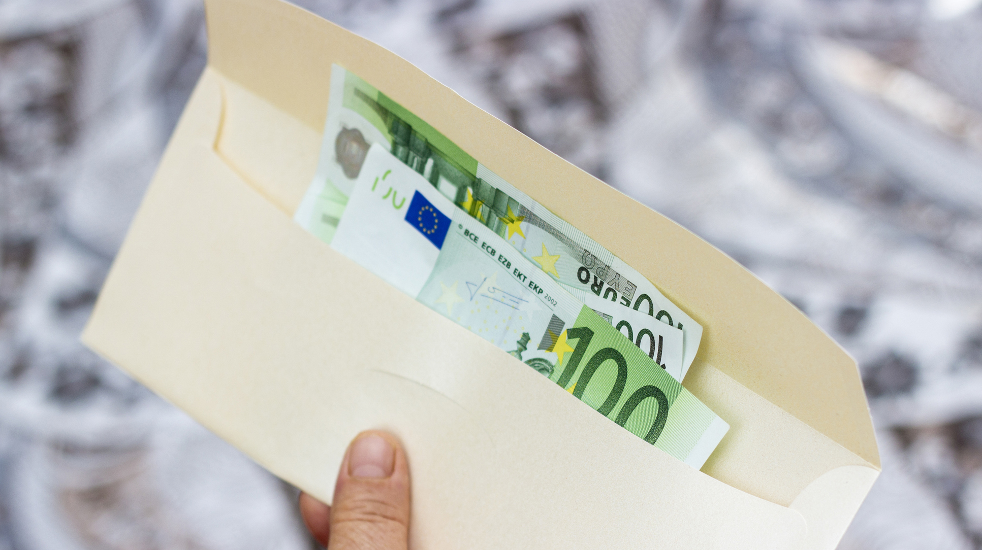 Group of one hundred euro banknotes in envelope