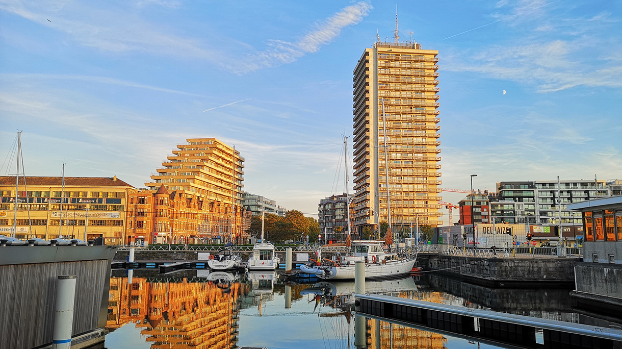 Buildings By River Against Sky In City