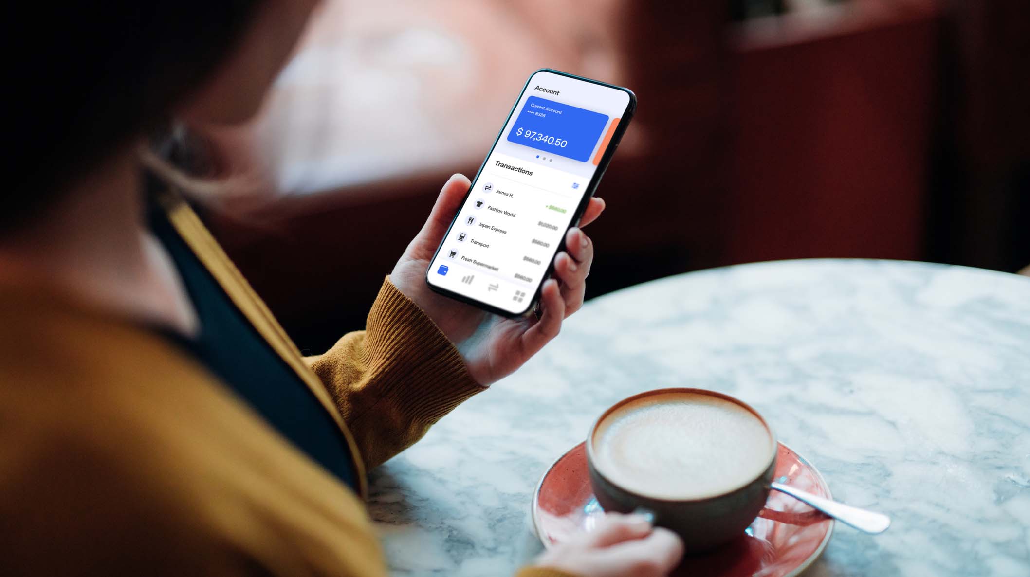 Close-up Shot Of Young Woman Managing Bank Account on Smartphone At Cafe