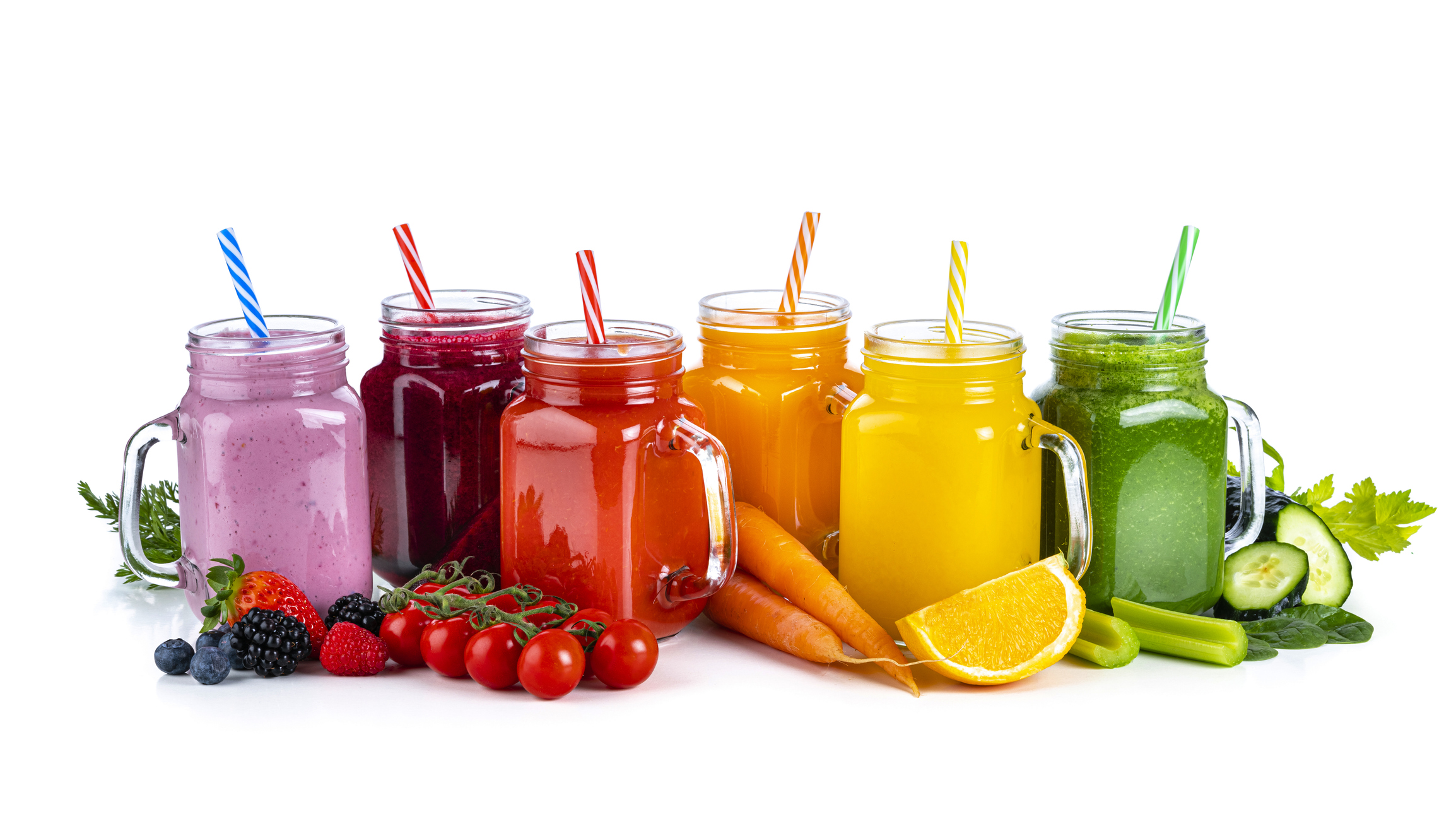 Healthy rainbow colored fruits and vegetables smoothies isolated on white background
