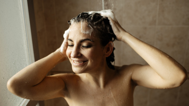 Portrait of adult woman smiling while taking shower