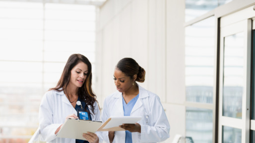 Female healthcare professionals meet to discuss patient records