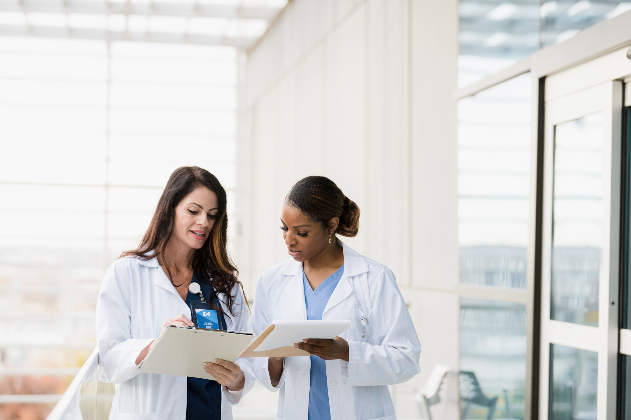 Female healthcare professionals meet to discuss patient records