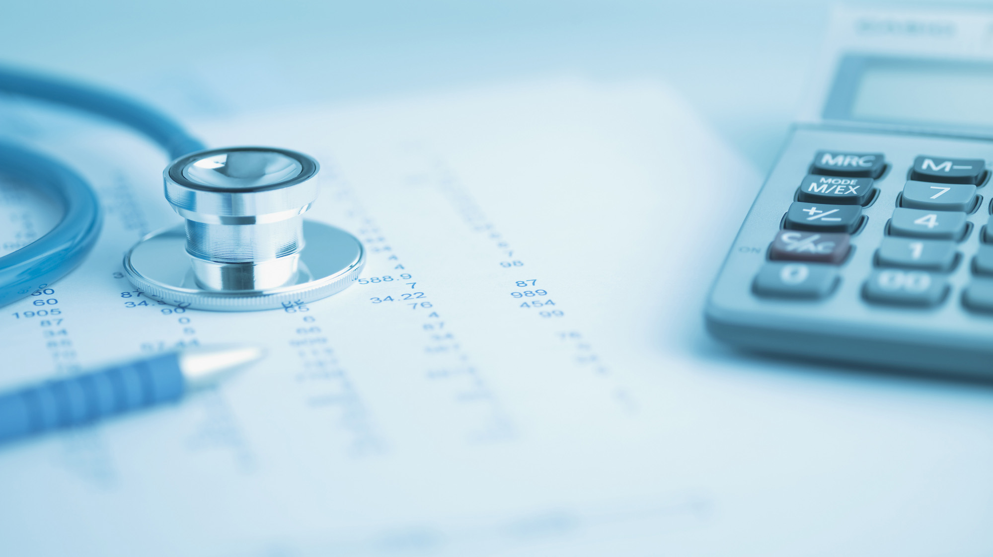 Close up of calculator, data and stethoscope