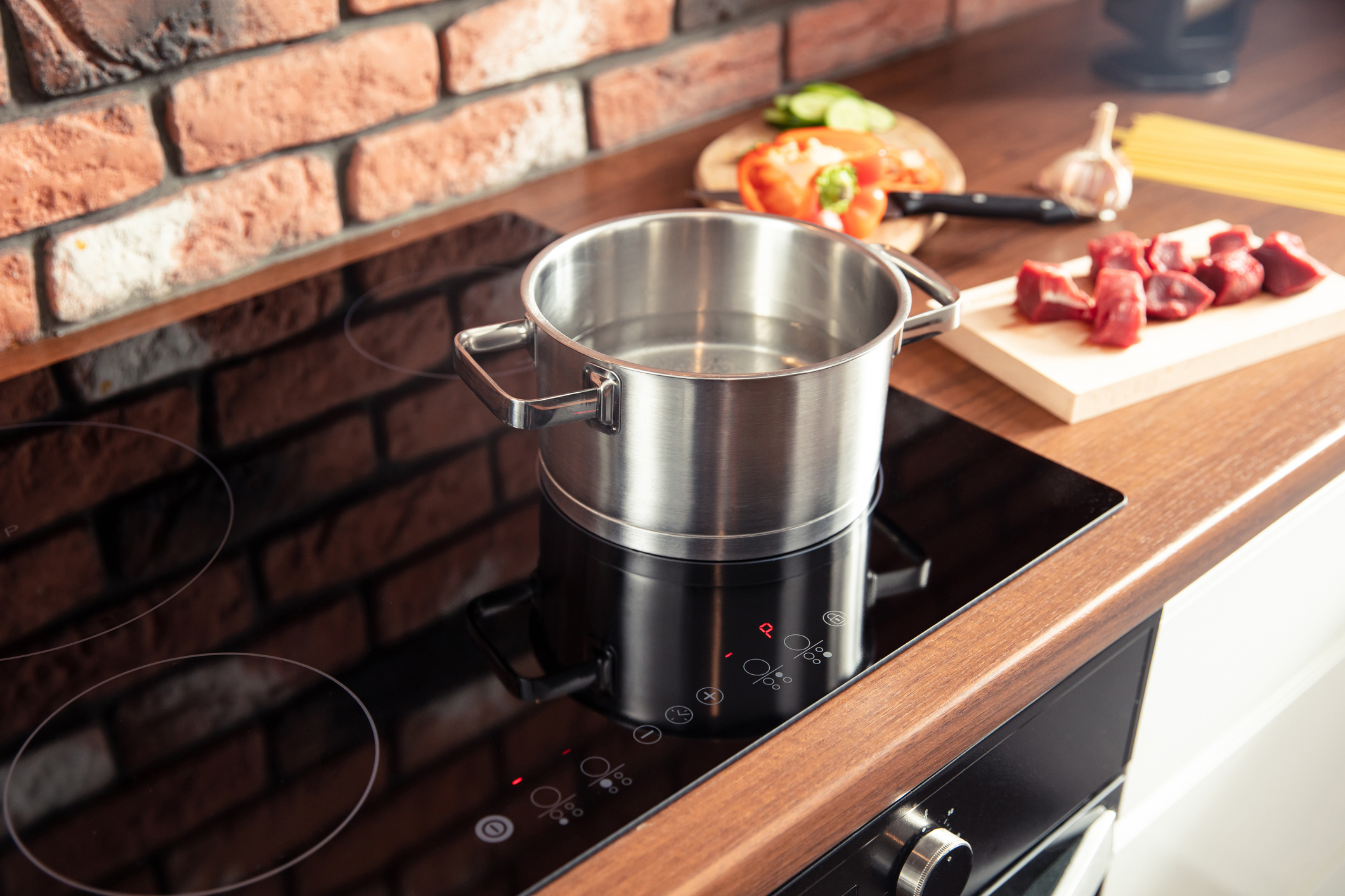 Metal pot stands on a modern induction cooker