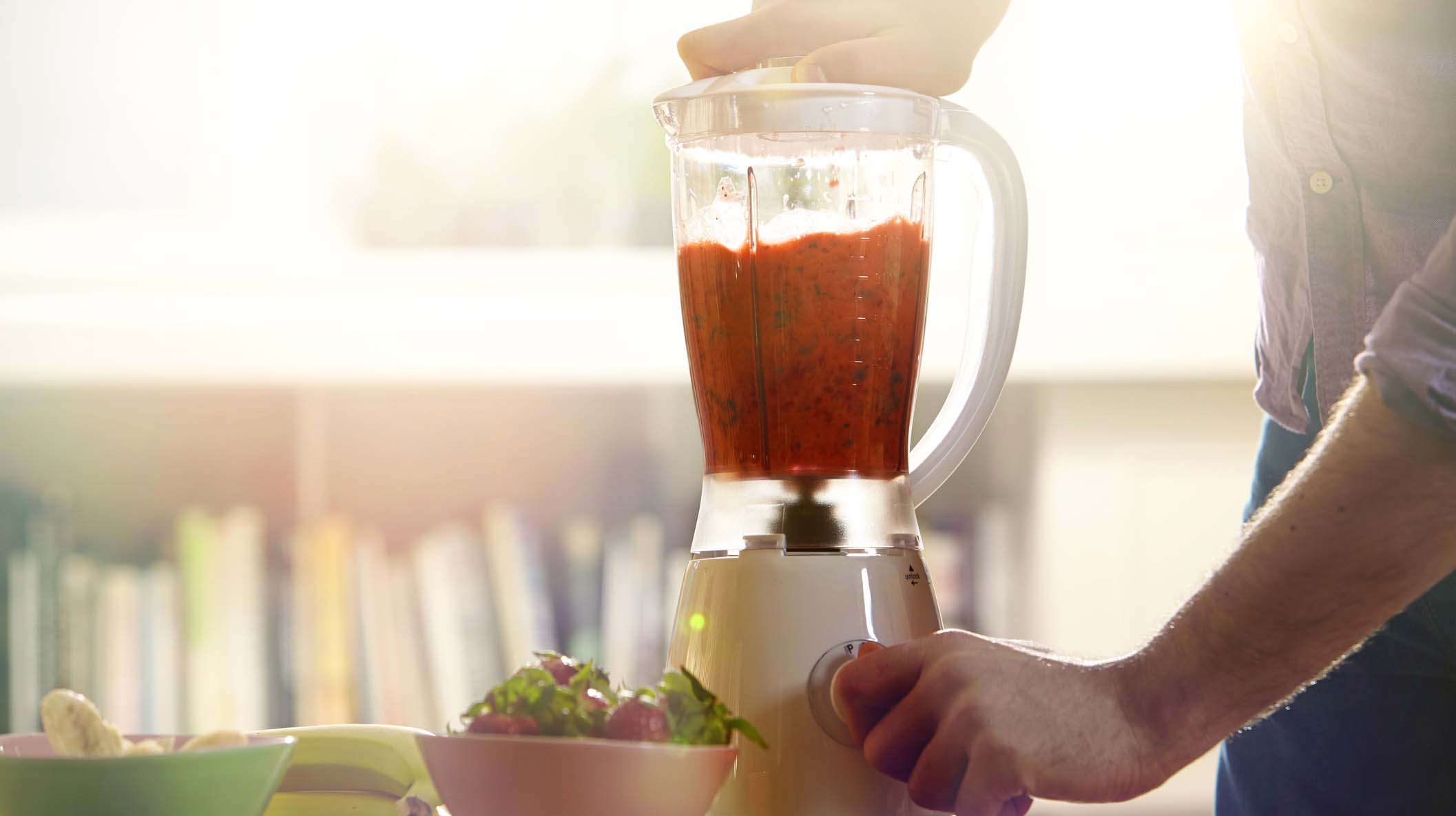 Man making a smoothie at home.