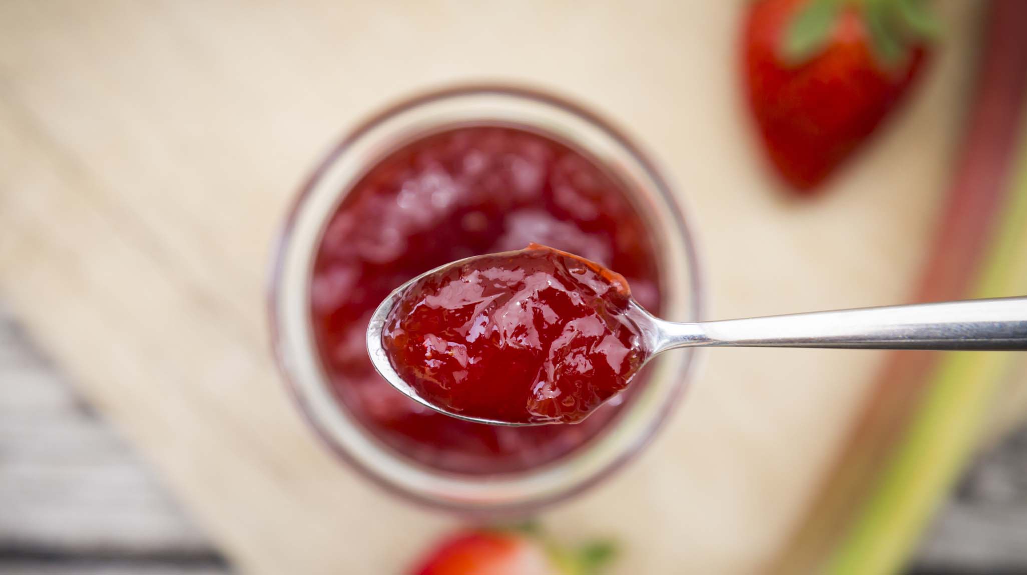 Glass of homemade strawberry rhubarb jam