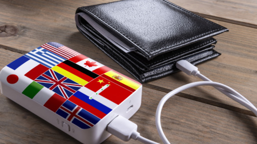 Money wallet and flag patterned power bank on wood desk.