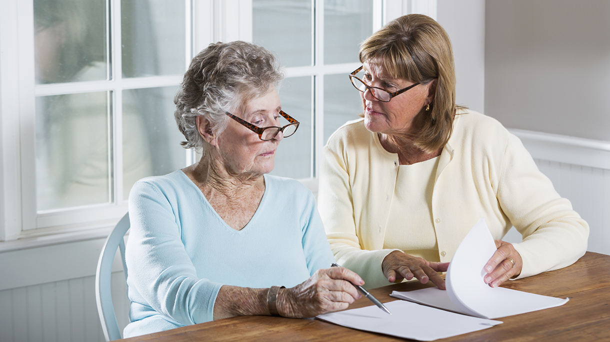 Elderly woman reading paperwork