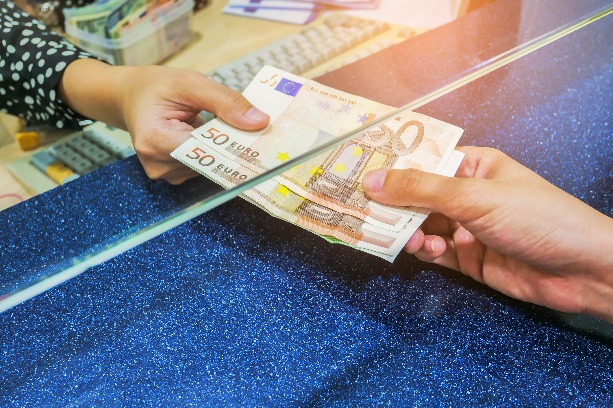 Female hand with money in cash department window. Currency exchange concept. Euro banknote. EUR . cash on counter bank. Hand giving cash and hand receiving cash. payday paying cashier access