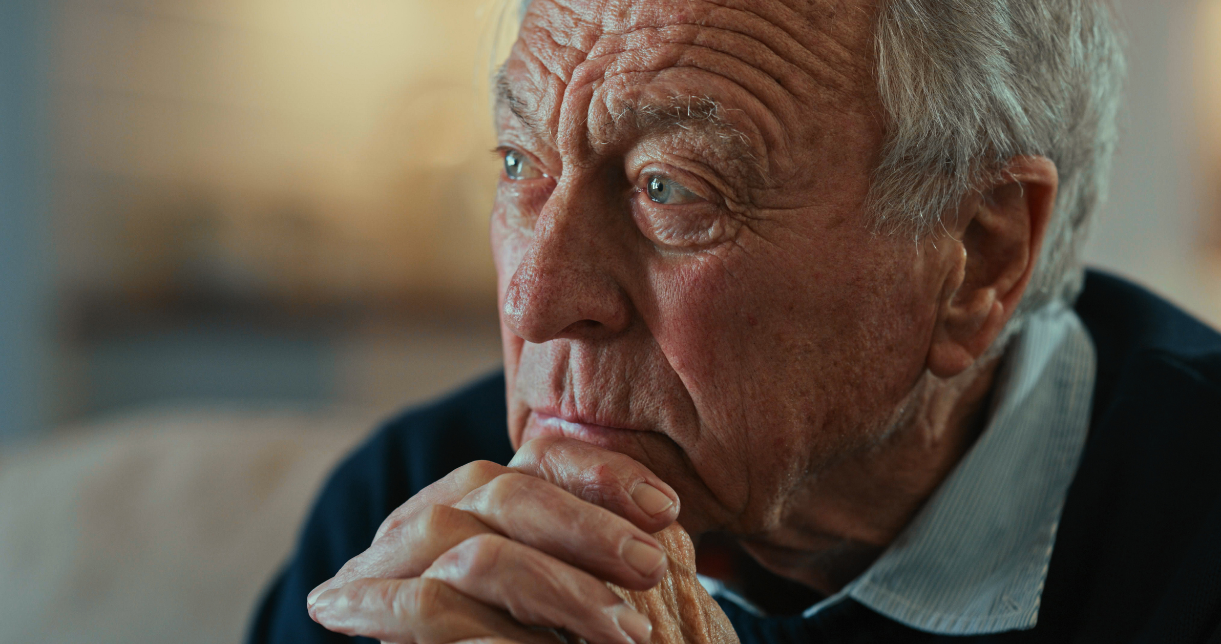 Shot of a senior man sitting alone at home and looking contemplative