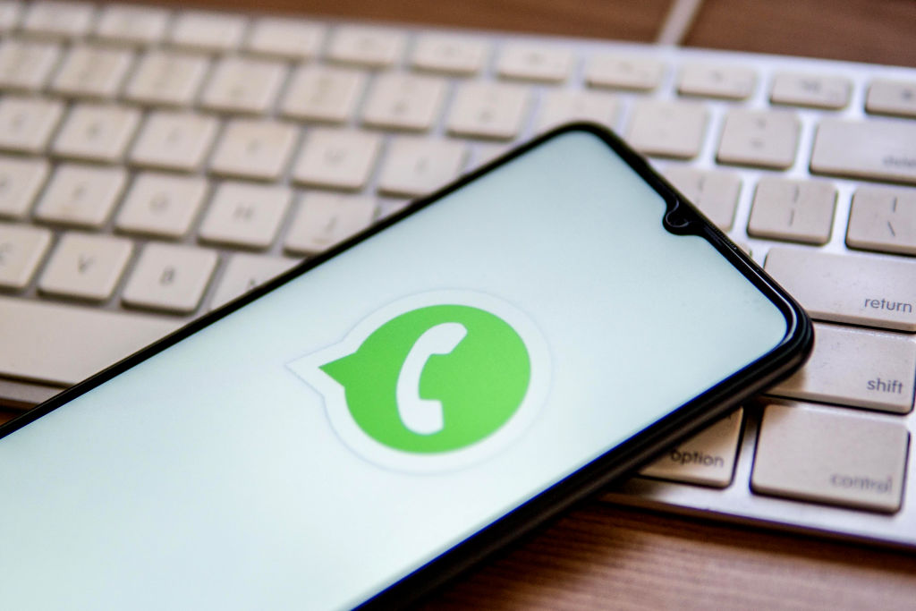 In this photo illustration, a WhatsApp logo seen displayed