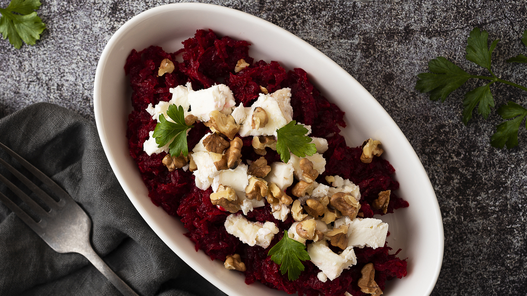 Raw beetroot salad with goat cheese and roasted walnuts