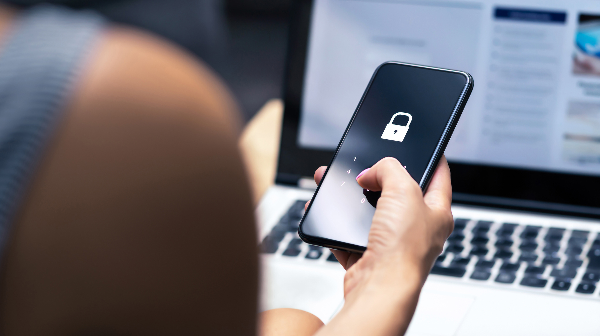 Phishing, mobile phone hacker or cyber scam concept. Password and login pass code in smartphone. Online security threat and fraud. Female scammer with cellphone and laptop.