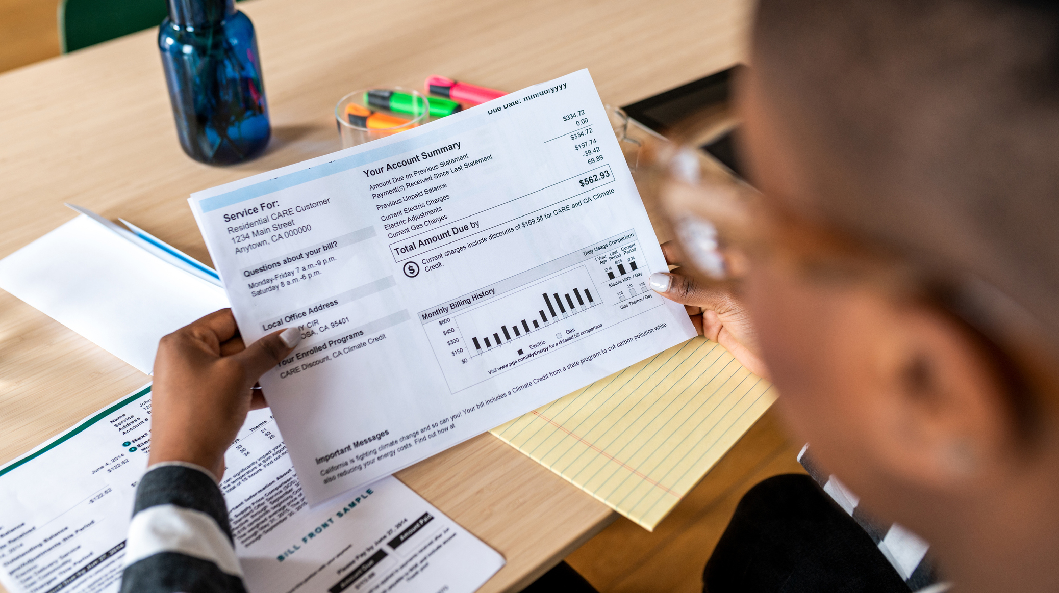 A young woman looks at the electricity bill