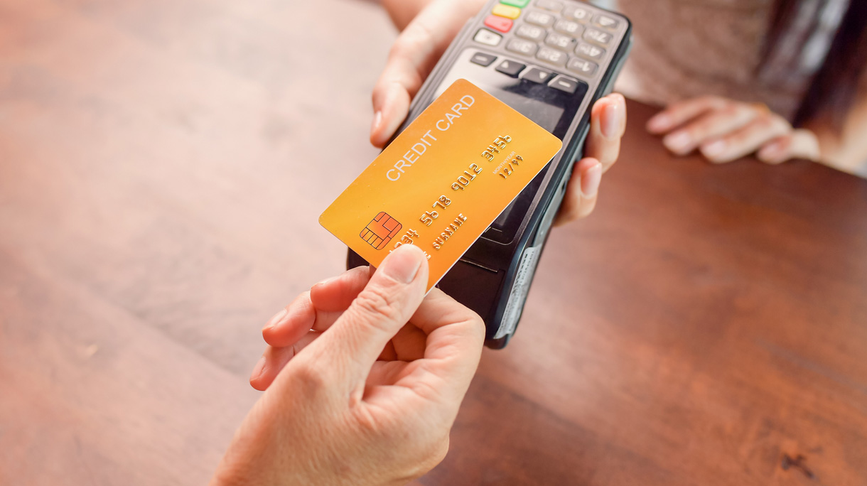 Person paying with a credit card using a credit card terminal