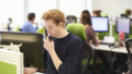 Young man taking call in call centre