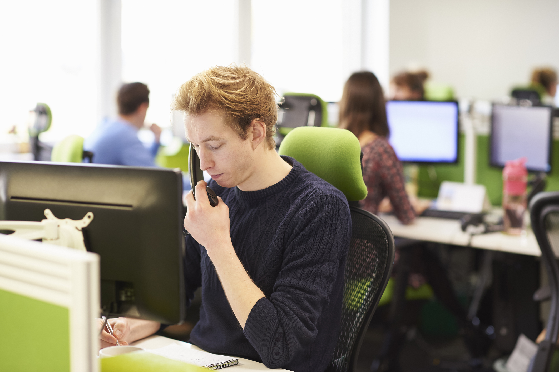 Young man taking call in call centre