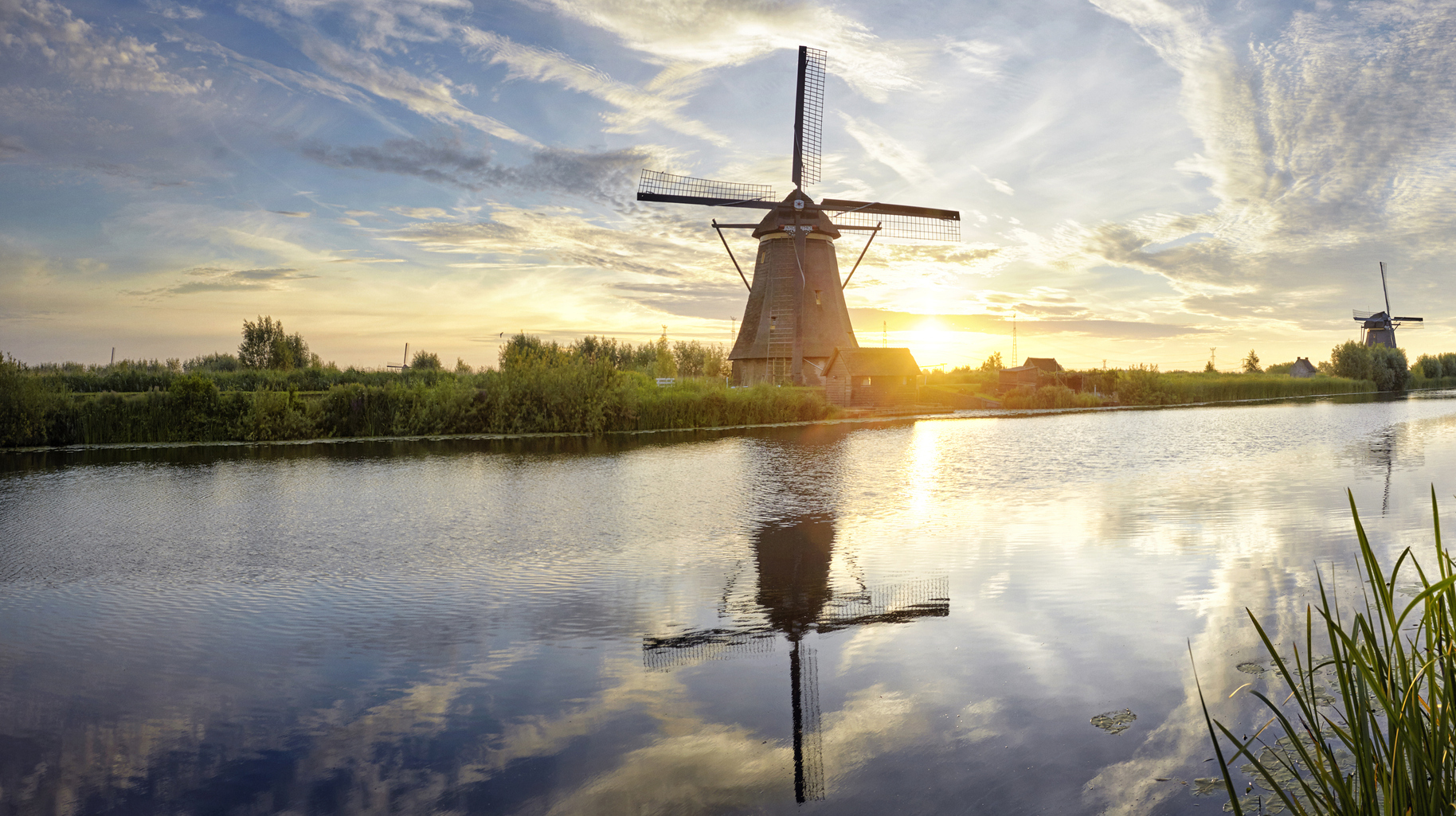 Windmills and river at sunrise panoramic, Kinderdijk, Netherlands