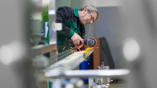 Industrial worker  grinding in manufacturing plant.