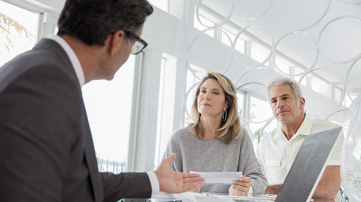 Couple talking to financial advisor