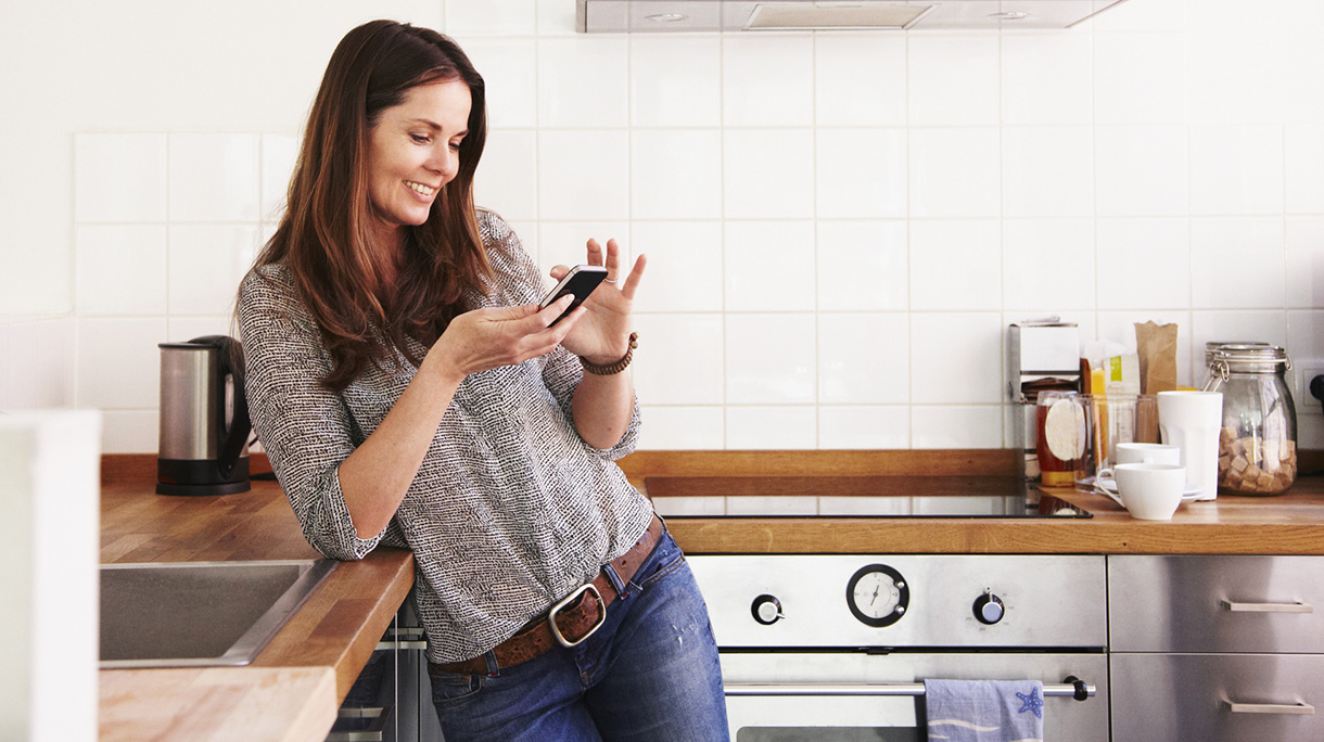 Middle-aged woman texting on her smartphone