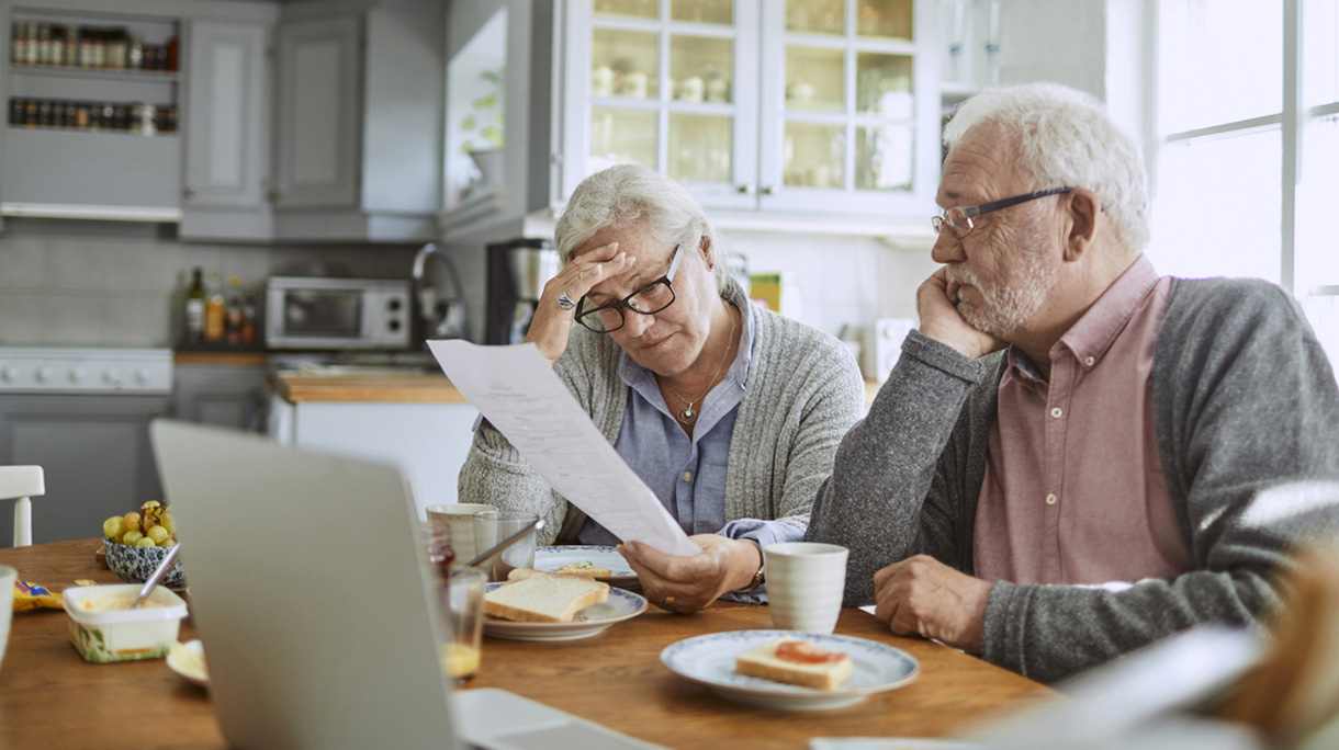 Senior couple having breakfast and doing bills