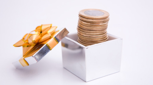 Gift box with a tower of coins coming out of it