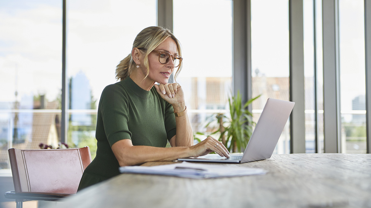Mature woman using laptop on table at home