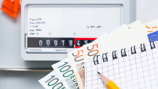 Payment of utility services, concept image. Notebook with Euro bills on the background of a gas meter