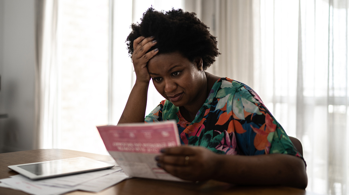 Worried woman looking for financial bills at home