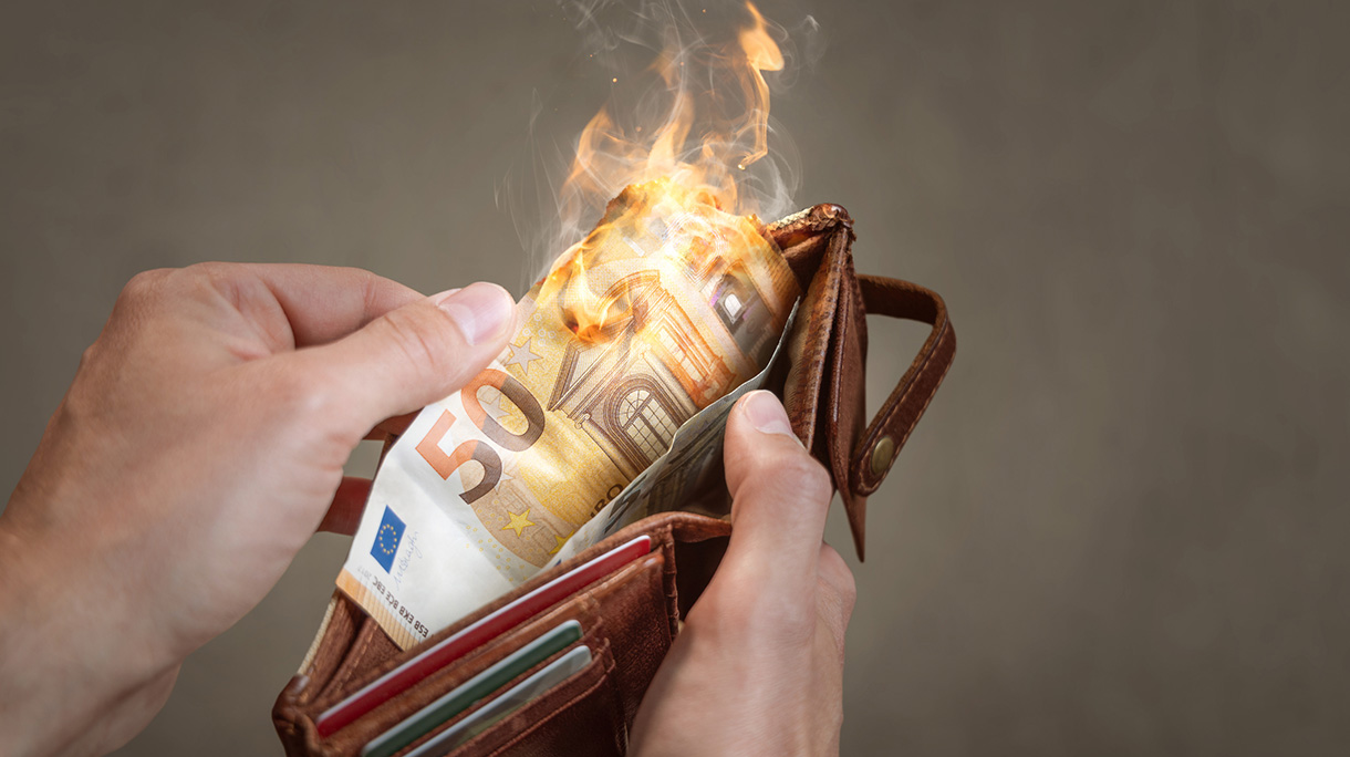 A burning 50 Euro bill in a wallet
