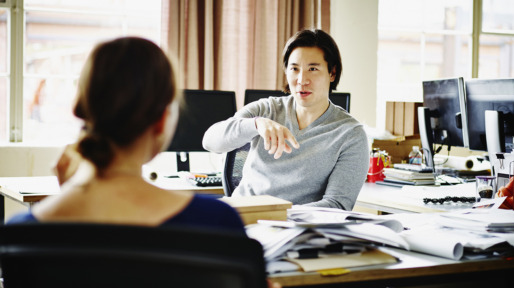 Coworkers discussing project in office