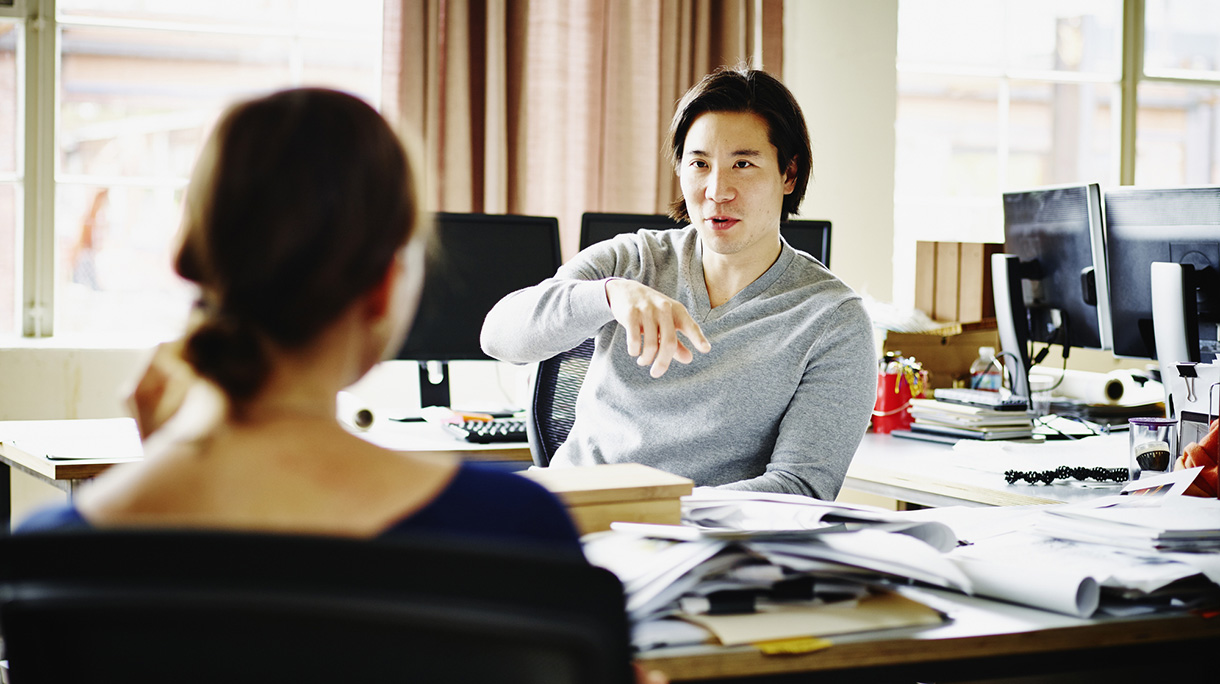 Coworkers discussing project in office