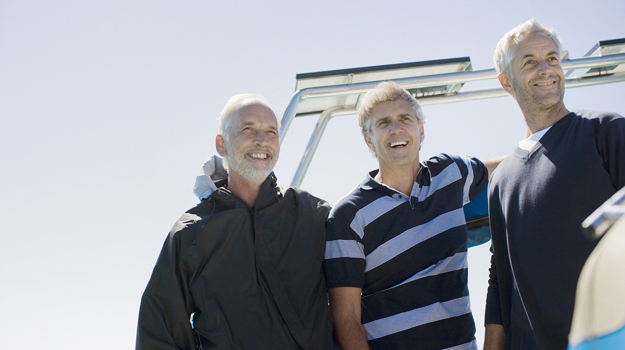 Friends standing on deck of boat
