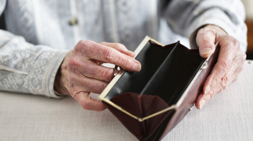 hands of senior adult holding empty purse