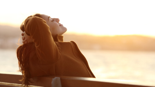 Vrouw op bankje in de zon