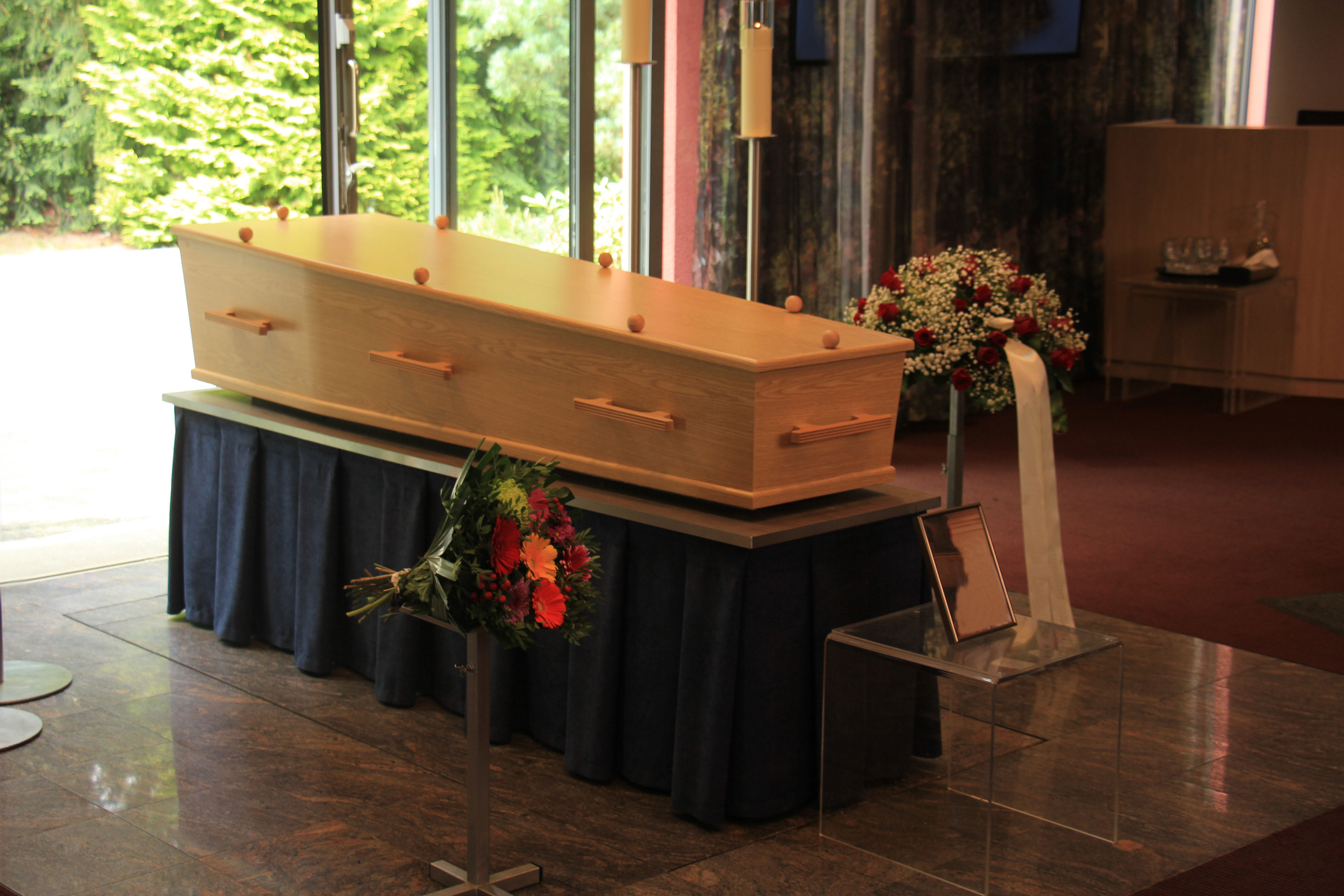 Wooden casket with funeral flowers
