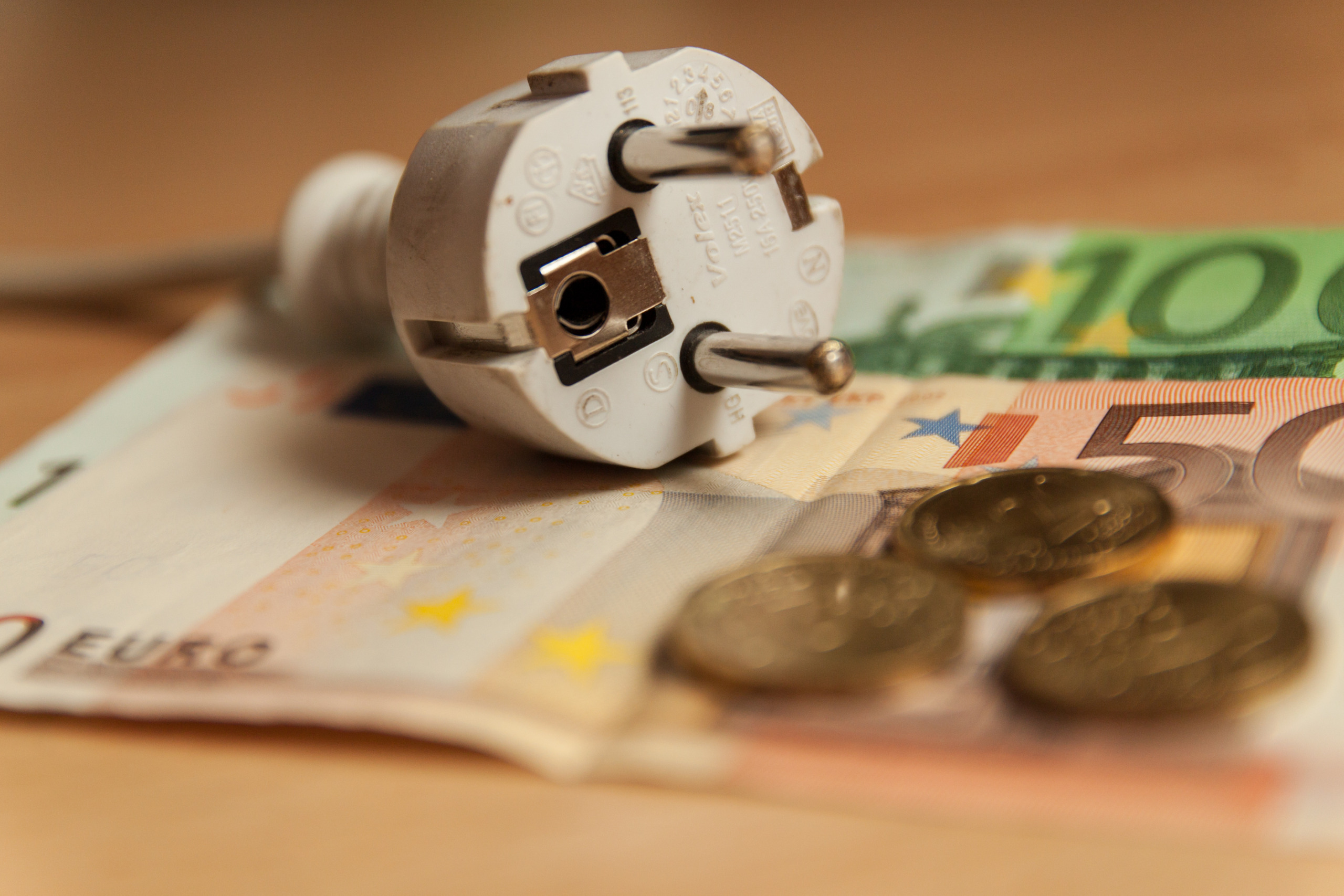 Multiple socket and Euro banknotes on white background, close-up