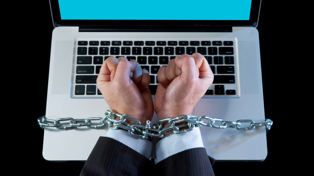 business-man-addicted-to-work-bond-with-chain-to-computer-picture-id524580373