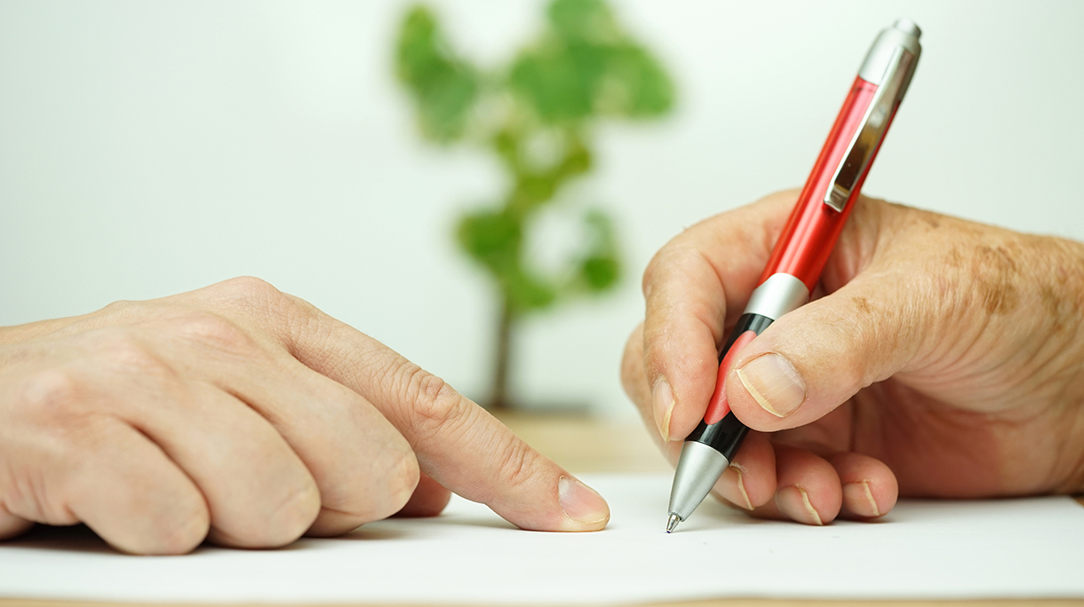 Hand of young adult pointing  elderly person where to sign