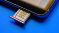 Smart phone and sim card on blue background