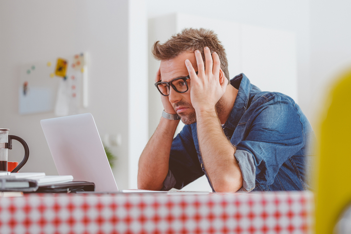 Worried man looking at the laptop screen