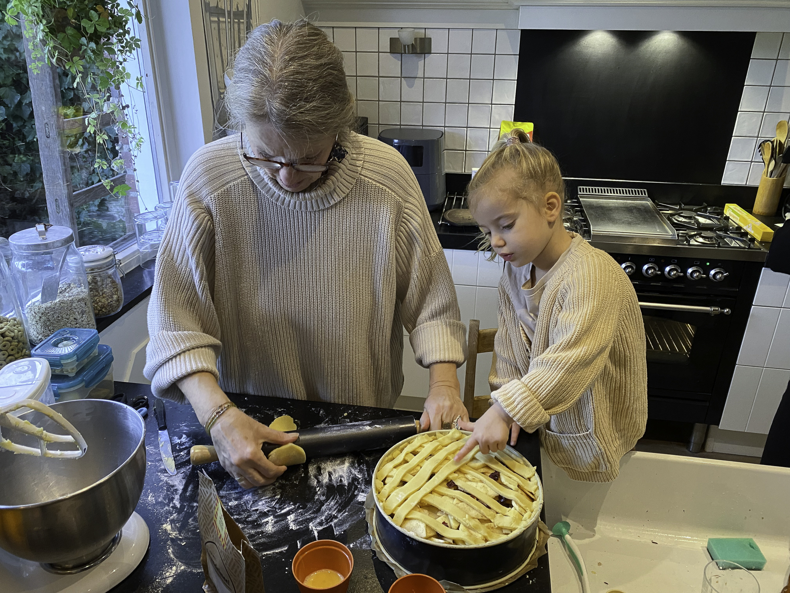 grootmoeder en kleindochter bakken appeltaart