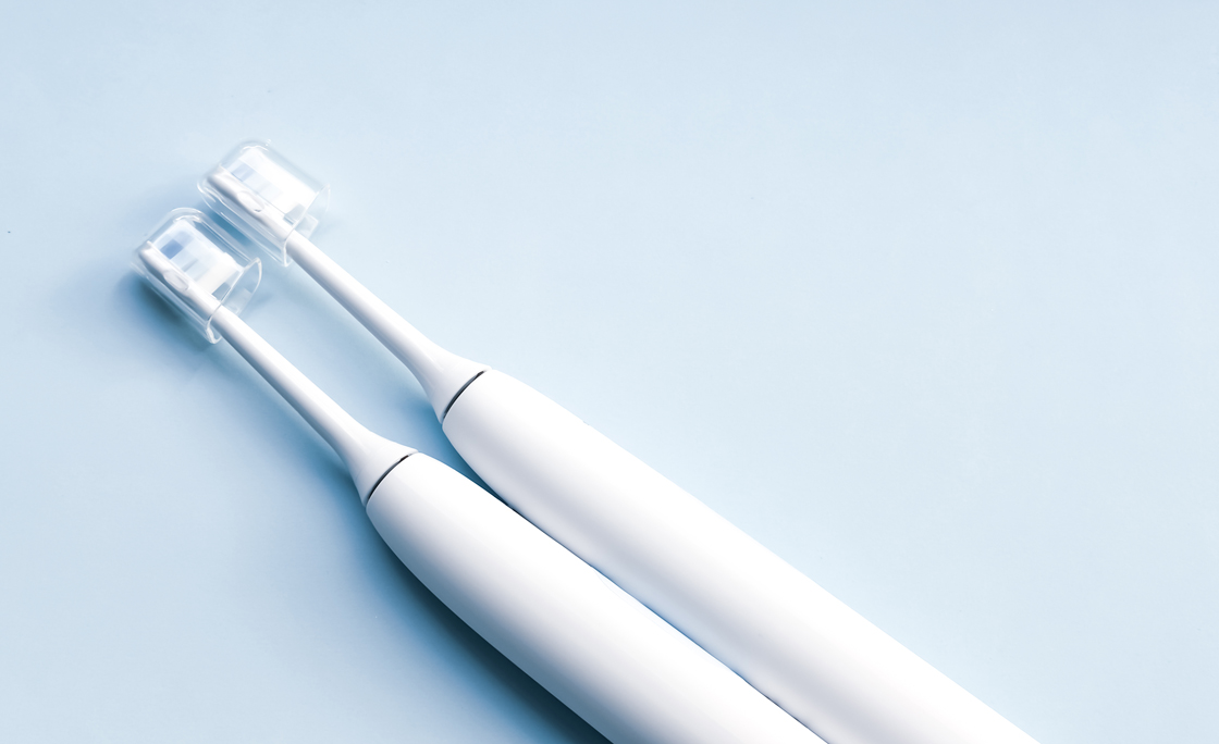 High Angle View Of Toothbrushes Against White Background