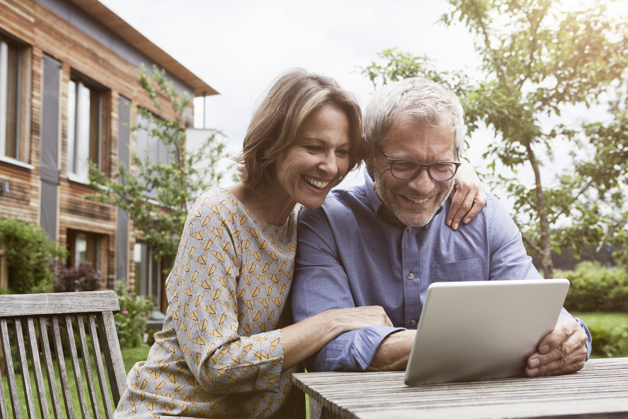 Ouder koppel is in de tuin bezig op tablet